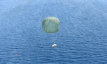 A low-cost, low-altitude bundle floats to the designated drop zone location in front of an approaching U.S. Air Force C-130 Hercules near Cebu, Philippines, as part of the current iteration of a rotational Air Contingent in the Philippines Oct. 5, 2016. For the exchange, C-130 Hercules aircraft and crews from Yokota Air Base's 374th Airlift Wing flew with members of the Philippine Air Force's 220th Airlift Wing, from Brig. Gen. Benito N. Ebuen Air Base, Lapu-Lapu City, Philippines, and discussed the intricacies of LCLA bundle drops. Two C-130s and crews from 374th Airlift Wing, Yokota Air Base, Japan, the 36th Contingency Response Group from Andersen Air Force Base, Guam, and other units from across U.S. Pacific Command conducted bilateral training missions and subject matter expert exchanges alongside their Philippine Air Force counterparts. The Air Contingent is helping build the capacity of the Philippine Air Force and increases joint training, promotes interoperability and provides greater and more transparent air and maritime situational awareness to ensure safety for military and civilian activities in international waters and airspace. Its missions include air and maritime domain awareness, personnel recovery, combating piracy, and assuring access to the air and maritime domains in accordance with international law. (U.S. Air Force photo by Capt. Mark Lazane)