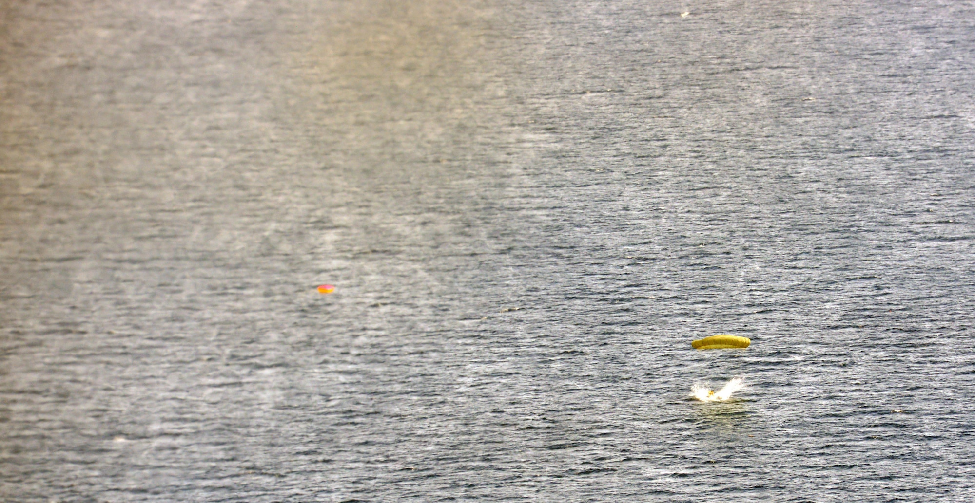 A low-cost, low-altitude bundle splashes down on target within the designated drop zone location near Cebu, Philippines, as part of the current iteration of a rotational Air Contingent in the Philippines Oct. 5, 2016. LCLA bundles are cost-effective means to reach austere drop zone locations without the need to land the aircraft and are a staple of C-130 operations for members of the 36th Airlift Squadron, 374th Airlift Wing, Yokota Air Base, Japan. For the exchange, Yokota-based C-130s and crew flew with members of the Philippine Air Force's 220th Airlift Wing, from Brig. Gen. Benito N. Ebuen Air Base, Lapu-Lapu City, Philippines, and discussed the intricacies of LCLA bundle drops. Two Yokota C-130s and crews, the 36th Contingency Response Group from Andersen Air Force Base, Guam, and other units from across U.S. Pacific Command conducted bilateral training missions and subject matter expert exchanges alongside their Philippine Air Force counterparts. The Air Contingent is helping build the capacity of the Philippine Air Force and increases joint training, promotes interoperability and provides greater and more transparent air and maritime situational awareness to ensure safety for military and civilian activities in international waters and airspace. Its missions include air and maritime domain awareness, personnel recovery, combating piracy, and assuring access to the air and maritime domains in accordance with international law. (U.S. Air Force photo by Capt. Mark Lazane)