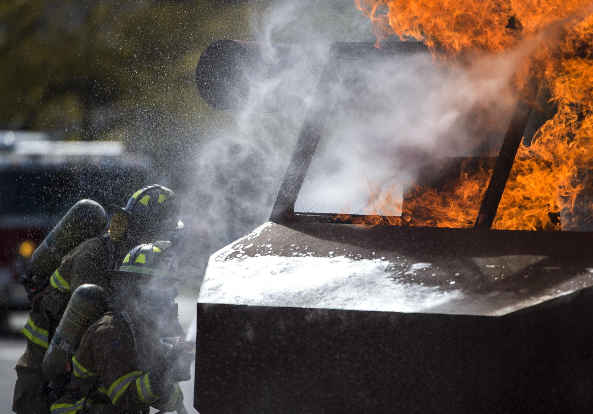 Airman 1st Class Daquonne Jamison and Senior Airman Brandon O’Connell, 11th Civil Engineer Squadron firefighters, spray a firehose on a simulation helicopter during a Fire Prevention Week demonstration at Joint Base Andrews, Md., Oct. 12, 2016. To educate the public on fire safety, JBA demonstrated fire response procedures, vehicle extraction techniques and building evacuation steps. (U.S. Air Force Photo by Senior Airman Philip Bryant)