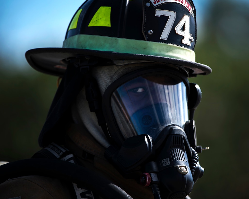 Airman 1st Class Daquonne Jamison, 11th Civil Engineer Squadron firefighter, pauses after extinguishing a fire during a Fire Prevention Week event at Joint Base Andrews, Md., Oct. 12, 2016. Jamison and other JBA firefighters demonstrated response procedures to an audience by extinguishing a fire on a simulation helicopter. (U.S. Air Force Photo by Senior Airman Philip Bryant)