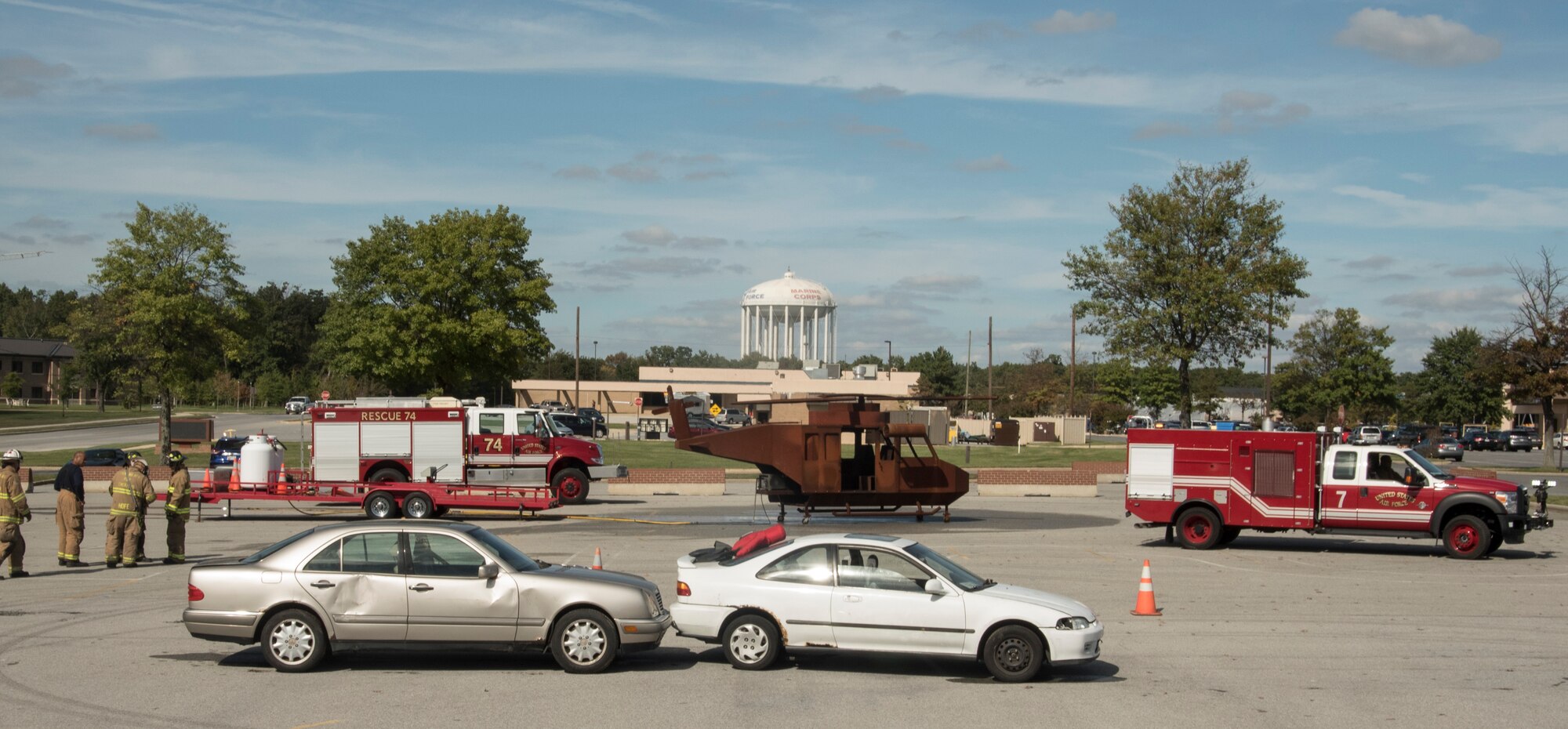 Vehicles, equipment and 11th Civil Engineer Squadron firefighters line a parking lot as part of a Fire Prevention Week demonstration at Joint Base Andrews, Md., Oct. 12, 2016. The demonstration included a simulated fire extinguishing and vehicle extraction. (U.S. Air Force Photo by Senior Airman Jordyn Fetter)