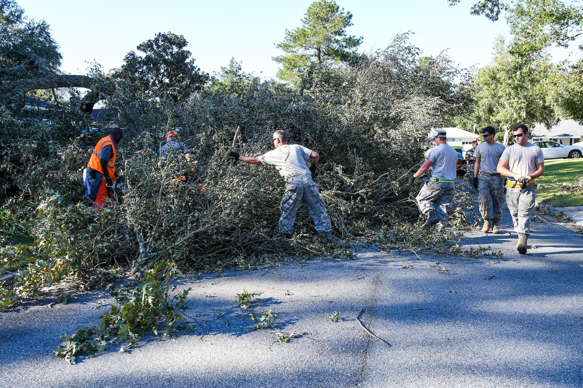 Citizen Airmen from the 116th Air Control Wing (ACW), Georgia Air National Guard, along with workers from Chatham County Public Works, clear fallen trees from roadways in the aftermath of Hurricane Matthew, Savannah, Ga., Oct. 9, 2016. The Airmen from the 116th ACW deployed to Savannah to support civil authorities, are working along side the Chatham County Public Works department to assist in road clearing and debris cleanup operations. (U.S. Air National Guard photo by Senior Master Sgt. Roger Parsons)