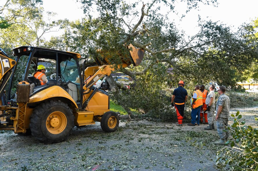 Citizen Airmen from the 116th Air Control Wing (ACW), Georgia Air National Guard, along with workers from Chatham County Public Works, clear fallen trees from roadways in the aftermath of Hurricane Matthew, Savannah, Ga., Oct. 9, 2016. The Airmen from the 116th ACW deployed to Savannah to support civil authorities, are working along side the Chatham County Public Works department to assist in road clearing and debris cleanup operations. (U.S. Air National Guard photo by Senior Master Sgt. Roger Parsons)