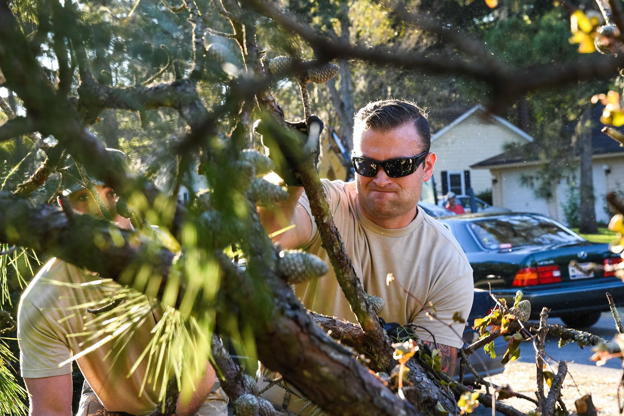 U.S. Air Force Staff Sgt. Kevin Phillips, 116th Air Control Wing (ACW), Georgia Air National Guard, throws a branch from a fallen tree on a debris pile while clearing roads in the aftermath of Hurricane Matthew, Savannah, Ga., Oct. 9, 2016. Citizen Airmen from the 116th ACW deployed to Savannah to support civil authorities, are working along side the Chatham County Public Works department to assist in road clearing and debris cleanup operations. (U.S. Air National Guard photo by Senior Master Sgt. Roger Parsons)