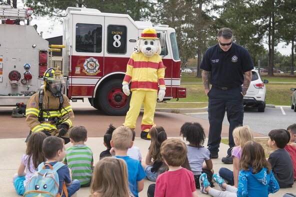 Airmen from the 23d Civil Engineer Squadron’s fire department talk to kids at the Child Development Center during Fire Prevention Week, Oct. 13, 2016, at Moody Air Force Base, Ga. These Airmen visited the CDC, Base Exchange, Commissary and local community to raise awareness on fire protection and smoke alarm safety from Oct. 11-14. (Photo by Airman 1st Class Greg Nash)