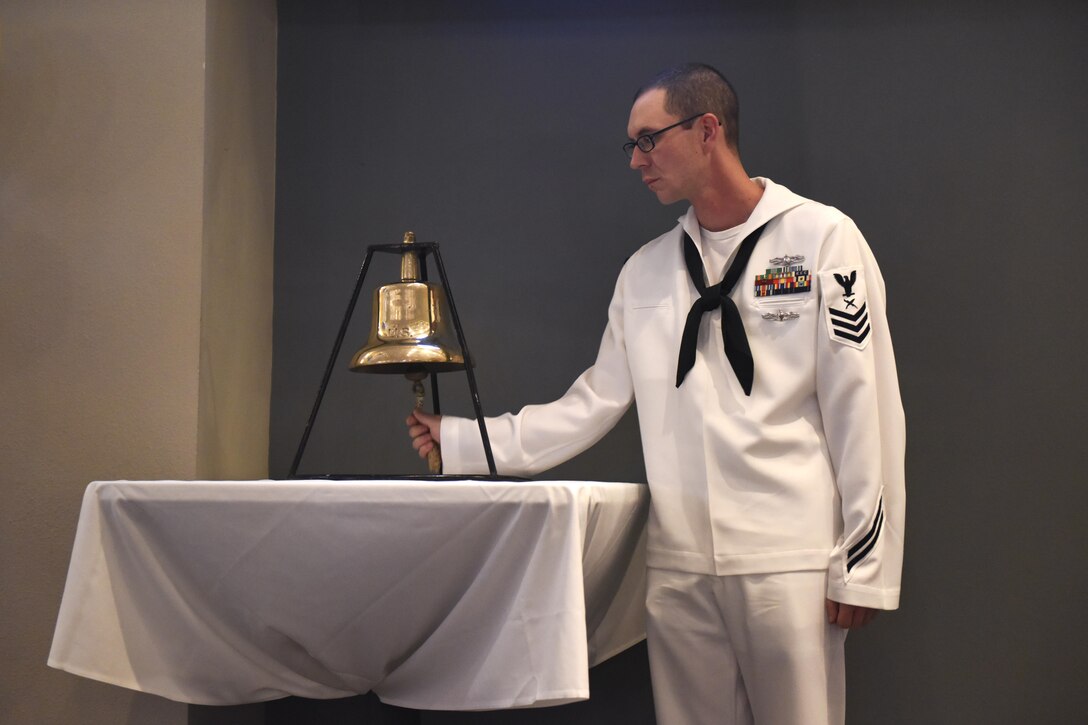 U.S. Navy Petty Officer 1st Class Matthew Todd, Center for Information Warfare Training Detachment Goodfellow instructor, rings a bell during the 241st Navy Birthday Ball at the Event Center on Goodfellow Air Force Base, Texas, Oct. 7, 2016. The bell symbolized the end and start of another year. (U.S. Air Force photo by Airman 1st Class Chase Sousa/Released)
