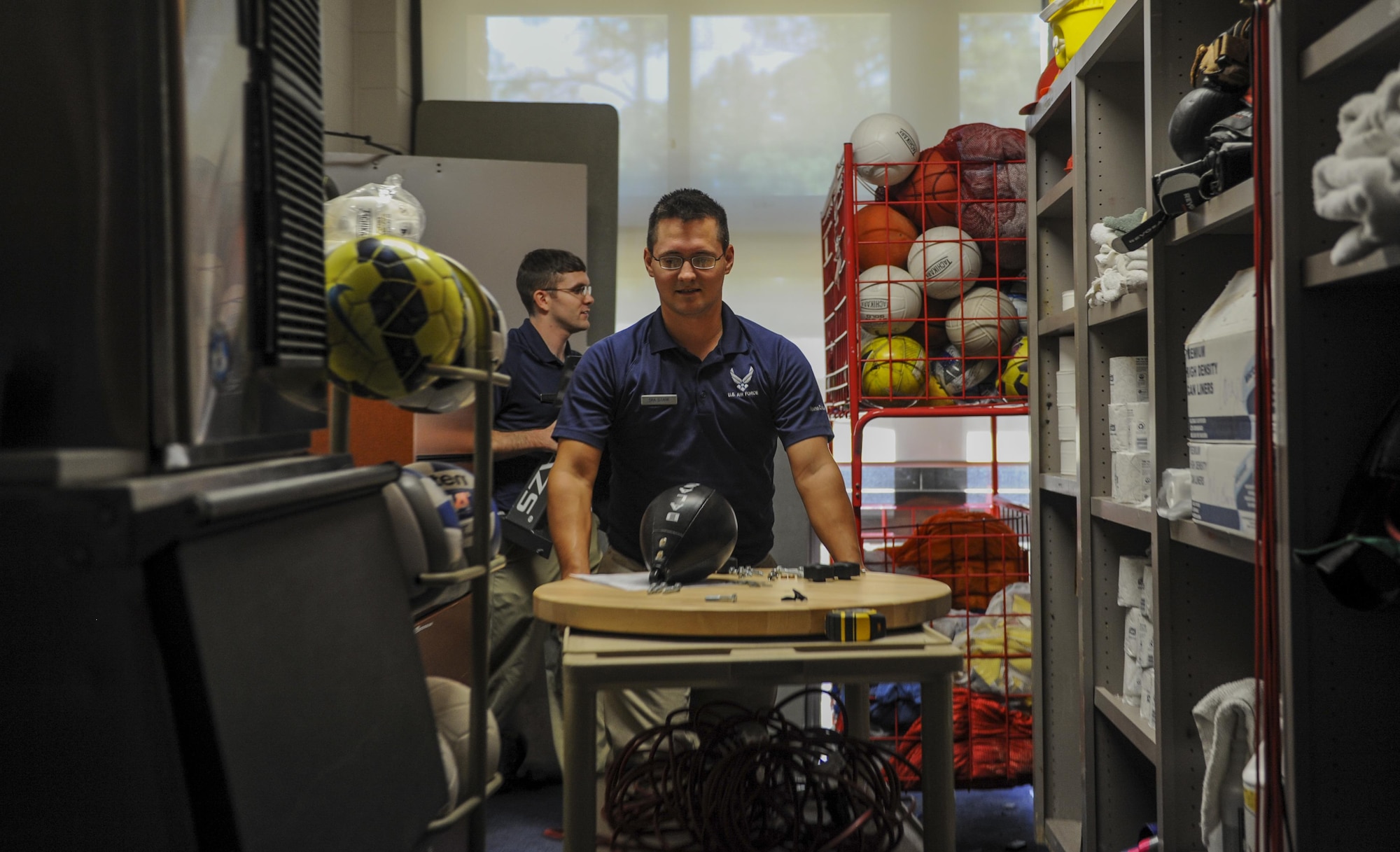 Staff Sgt. Michael Olaughlin,left, and Senior Airman Robert Stark, fitness specialists with the 1st Special Operations Force Support Squadron, prepare to set up a new speed bag in the Aderholt Fitness Center at Hurlburt Field, Fla., Oct. 11, 2016. Fitness specialists’ on-the-job training ranges from fitness fundamentals, proper equipment usage, nutrition and how the body works to get optimal results. (U.S. Air Force photo by Airman 1st Class Isaac O. Guest IV)