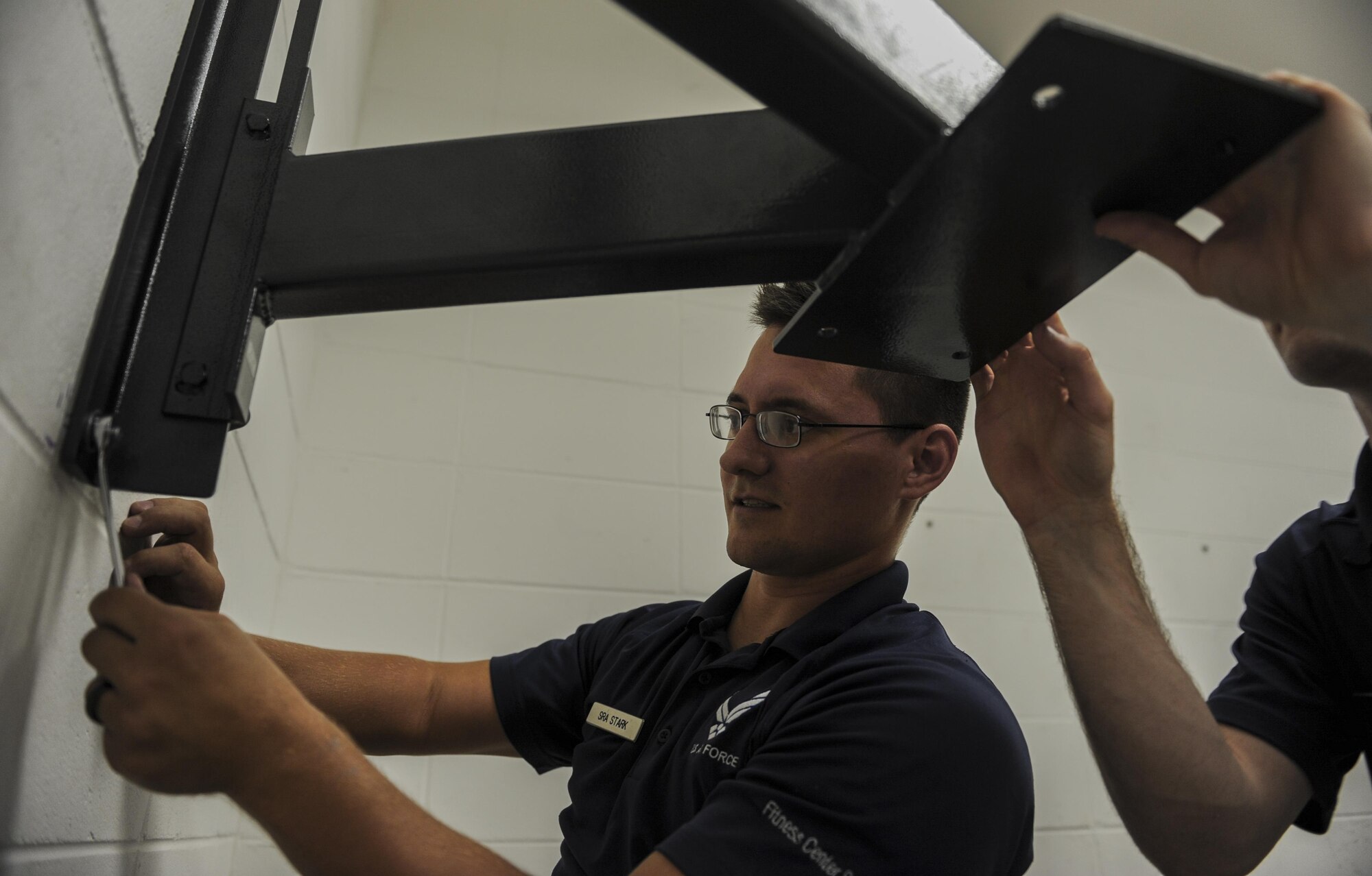 Senior Airman Robert Stark, a fitness specialist with the 1st Special Operations Force Support Squadron, sets up a speed bag in the Aderholt Fitness Center at Hurlburt Field, Fla., Oct. 11, 2016.  Fitness specialists receive one week of training in tech school solely based on fitness and receive on the job training once assigned to a fitness center. (U.S. Air Force photo by Airman 1st Class Isaac O. Guest IV)