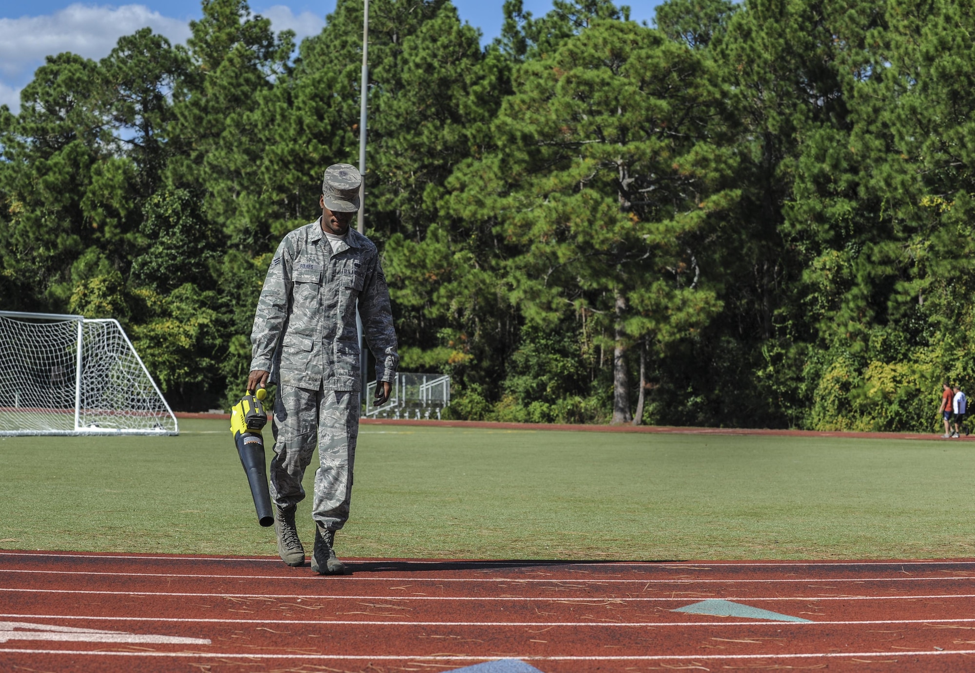 Senior Airman Rycardo Folkes, an assistant sports director with the 1st Special Operations Force Support Sqaudron, blows away debris on the track behind the Aderholt Fitness Center at Hurlburt Field, Fla., Oct. 12, 2016. An assistant sports director’s job includes guiding coaches and facilitating intermural sporting events. (U.S. Air Force photo by Airman 1st Class Isaac O. Guest IV)