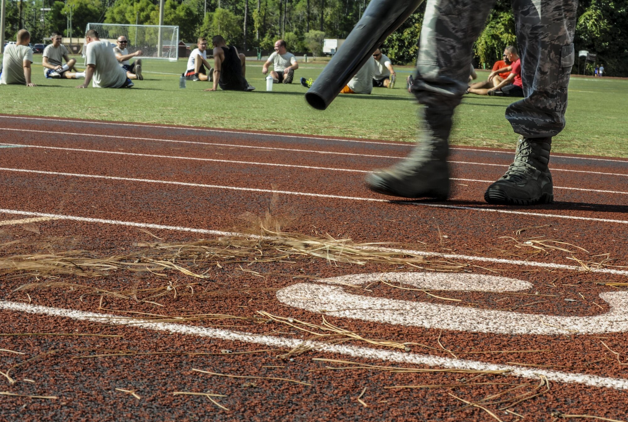 Senior Airman Rycardo Folkes, an assistant sports director with the 1st Special Operations Force Support Sqaudron, blows away debris on the track behind the Aderholt Fitness Center at Hurlburt Field, Fla., Oct. 12, 2016. An assistant sports director’s job includes guiding coaches and facilitating intermural sporting events. (U.S. Air Force photo by Airman 1st Class Isaac O. Guest IV)
