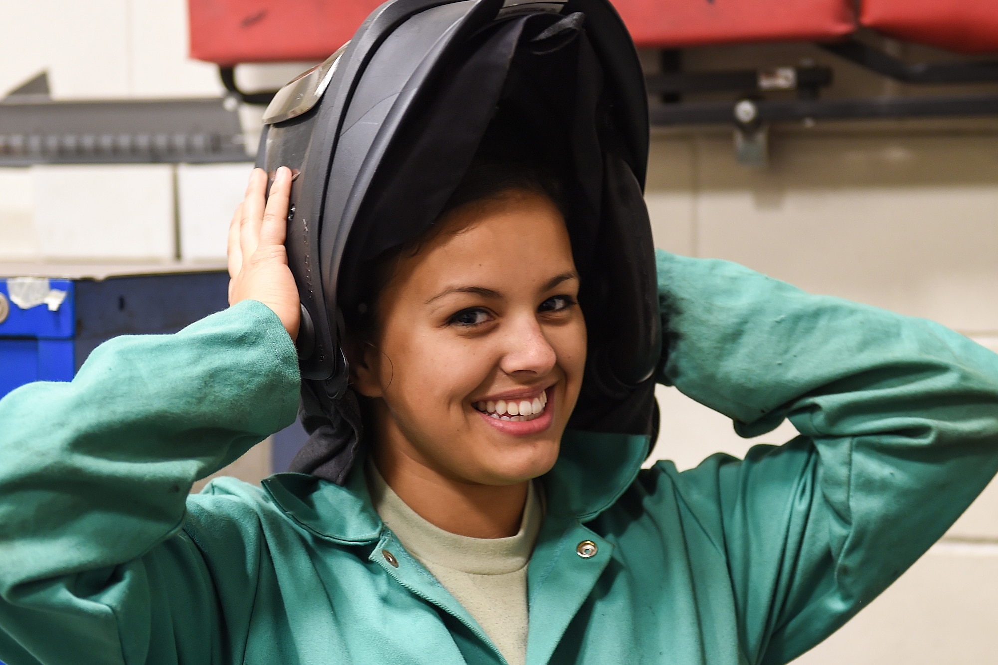 Airman 1st Class Morgan Williams, an aircraft metals technology apprentice with the 1st Special Operations Maintenance Squadron, dons her welding helmet at Hurlburt Field, Fla., Oct. 13, 2016. The welding helmet provides protection for the eyes, face and neck from flash burn, ultraviolet light, sparks, infrared light and heat. (U.S. Air Force photo by Senior Airman Jeff Parkinson)