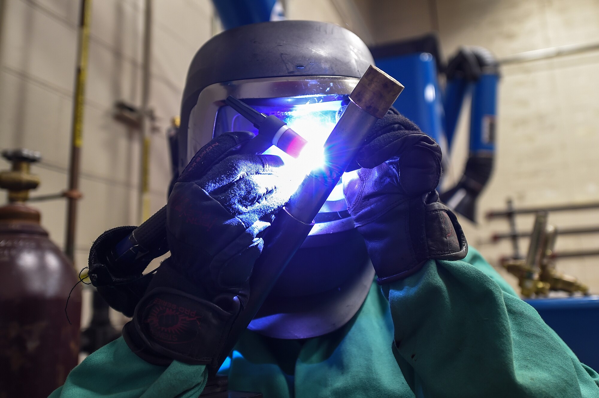 Airman 1st Class Morgan Williams, an aircraft metals technology apprentice with the 1st Special Operations Maintenance Squadron, welds pieces of certifying metal together at Hurlburt Field, Fla., Oct. 13, 2016. Aircraft metal technology Airmen use certifying metal to practice their welding techniques. (U.S. Air Force photo by Senior Airman Jeff Parkinson)