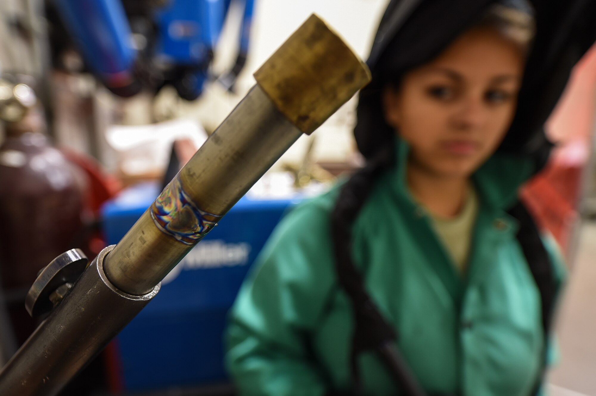 Airman 1st Class Morgan Williams, an aircraft metals technology apprentice with the 1st Special Operations Maintenance Squadron, looks over her finished welding work at Hurlburt Field, Fla., Oct. 13, 2016. Aircraft metal technology Airmen use welding to repair cracks and other various damages in aircraft parts to avoid having to order brand new parts. (U.S. Air Force photo by Senior Airman Jeff Parkinson)