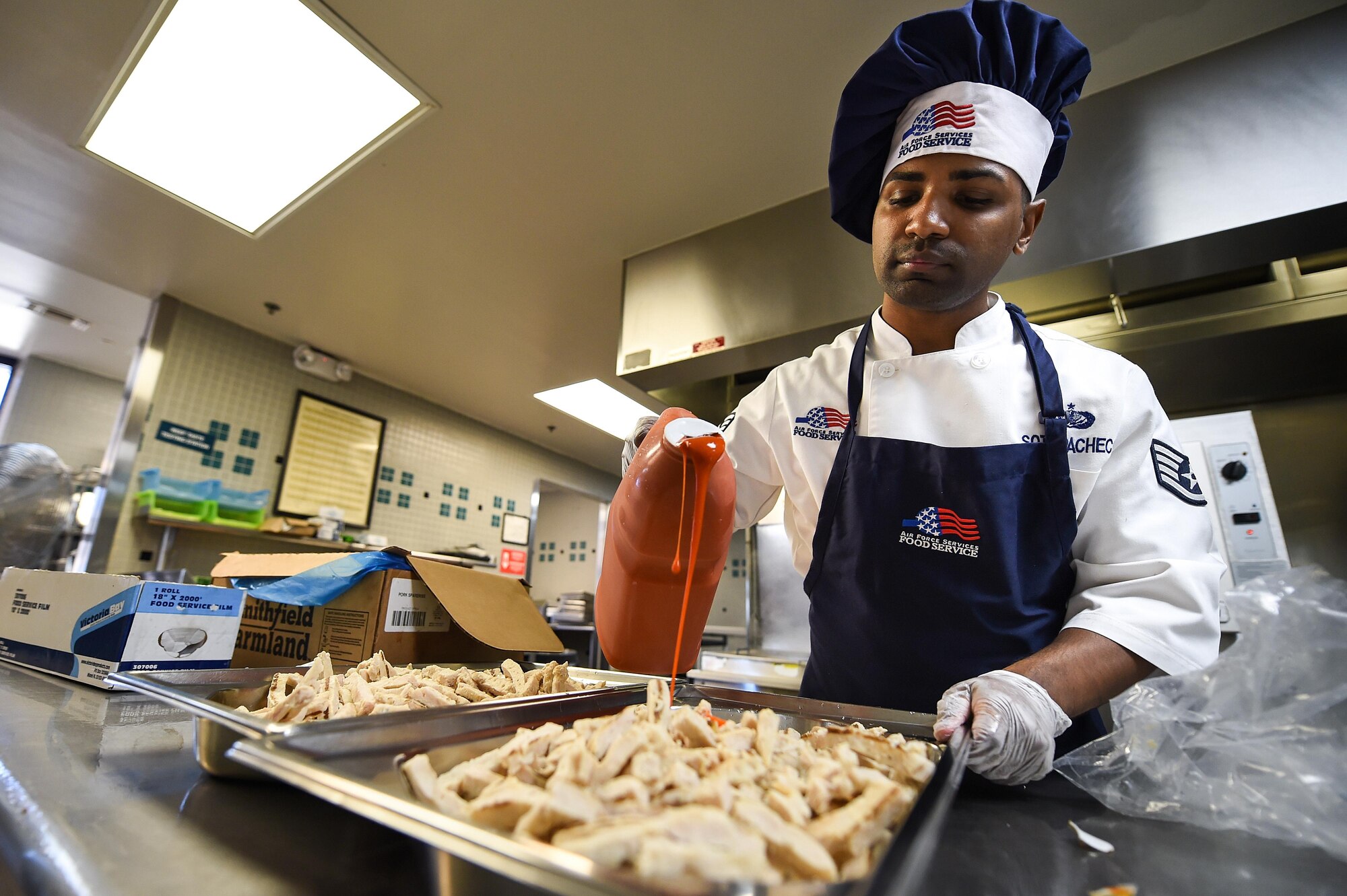 Staff. Sgt. Raymond Soto-Pacheco, a food shift supervisor with the 1st Special Operations Force Support Squadron, prepares grilled buffalo chicken at the Reef dining facility, Hurlburt Field, Fla., Oct. 13, 2016. Between the varieties of options provided by the buffet-style facility, the Reef makes around $1,780.00 worth of food per day. (U.S. Air Force photo by Senior Airman Jeff Parkinson)