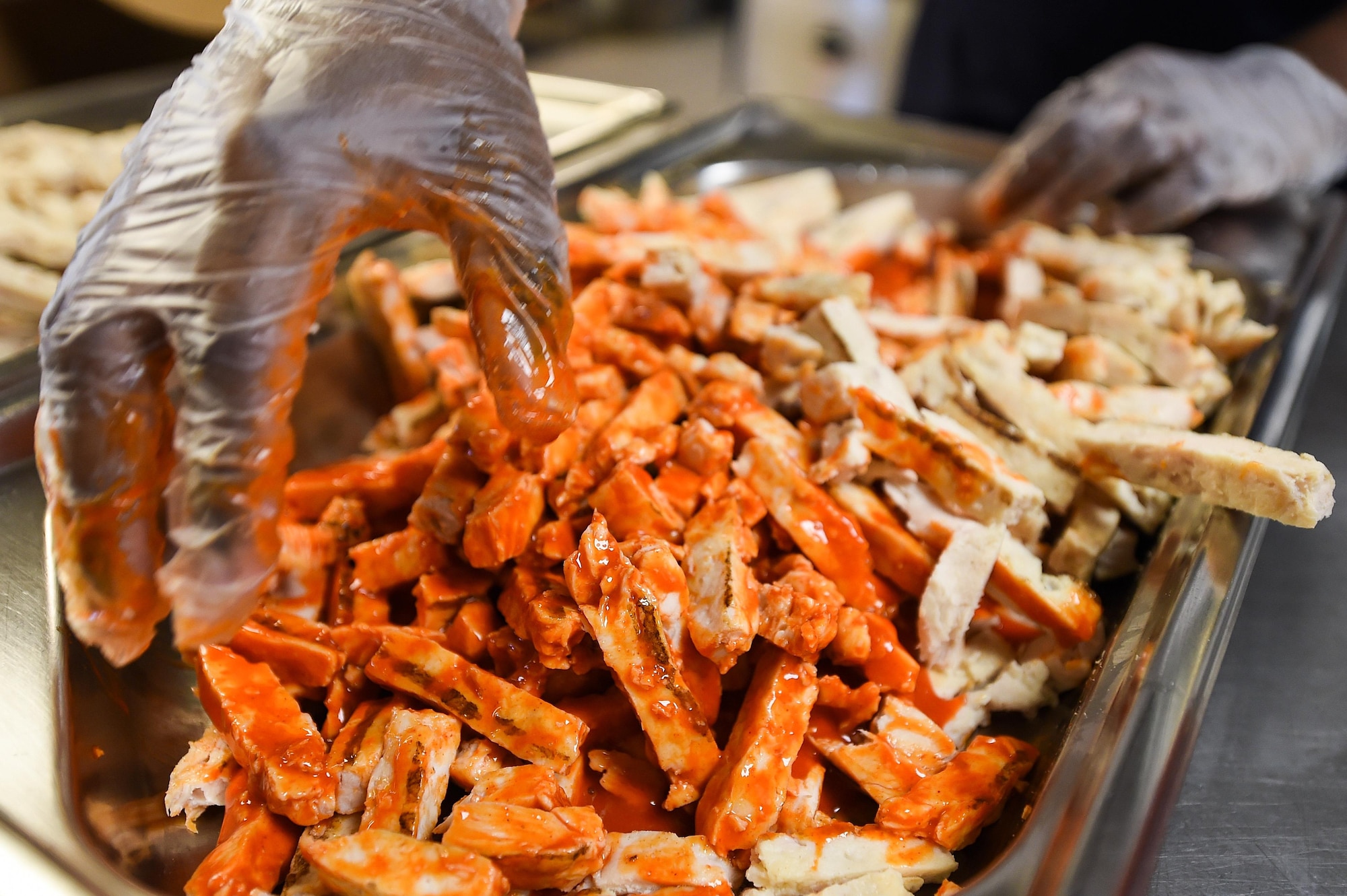 Staff. Sgt. Raymond Soto-Pacheco, a food shift supervisor with the 1st Special Operations Force Support Squadron, prepares grilled buffalo chicken at the Reef dining facility, Hurlburt Field, Fla., Oct. 13, 2016. With the Reef being the only buffet-style dining facility in the Air Force, it is able to supply customers with options that satisfy their dietary needs as well as their palate. (U.S. Air Force photo by Senior Airman Jeff Parkinson)