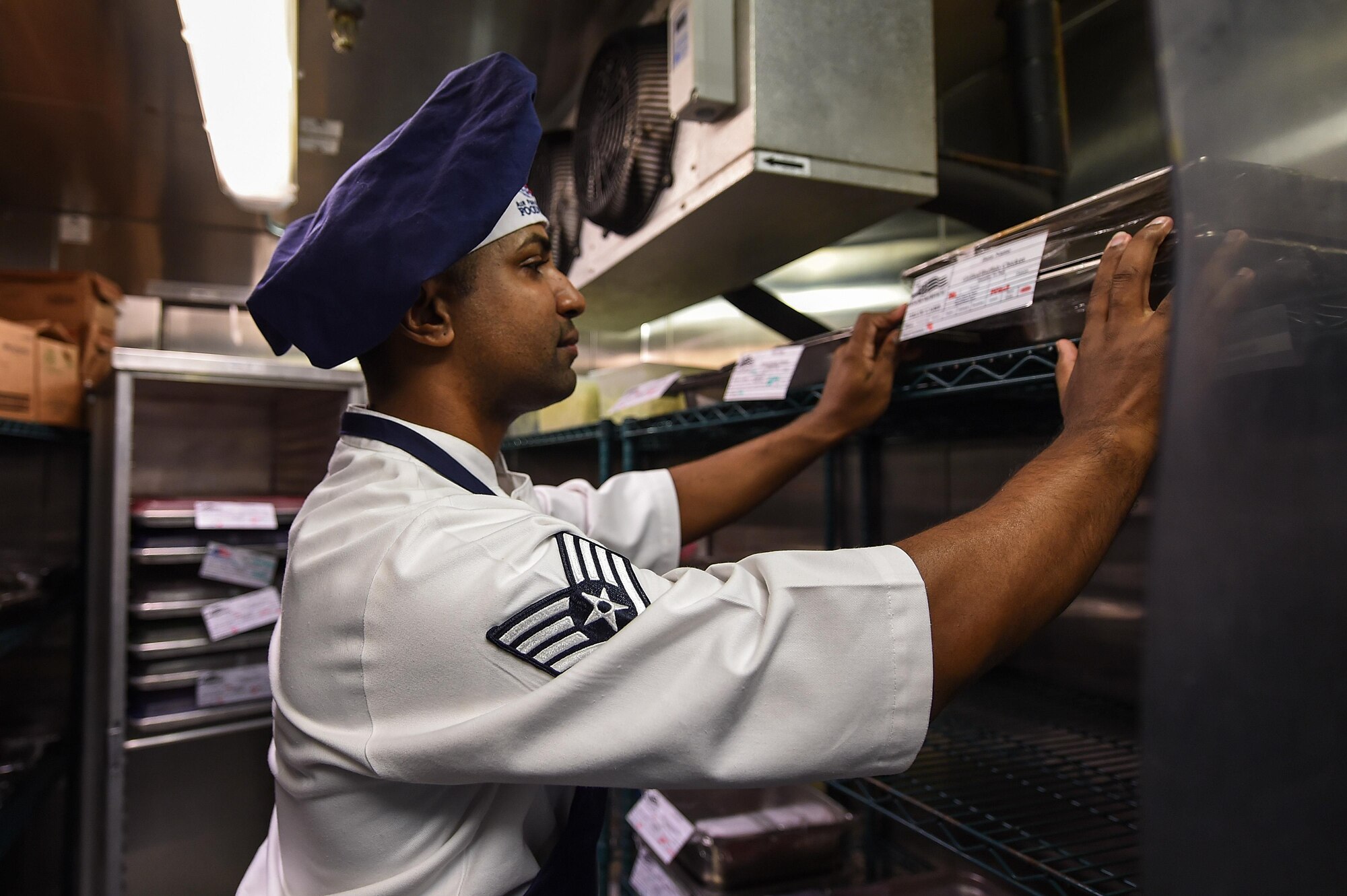 Staff. Sgt. Raymond Soto-Pacheco, a food shift supervisor with the 1st Special Operations Force Support Squadron, stores food to be cooked the next day at the Reef dining facility, Hurlburt Field, Fla., Oct. 13, 2016. To stay ahead of next day meal times, services Airmen begin meal prep the previous day. (U.S. Air Force photo by Senior Airman Jeff Parkinson)