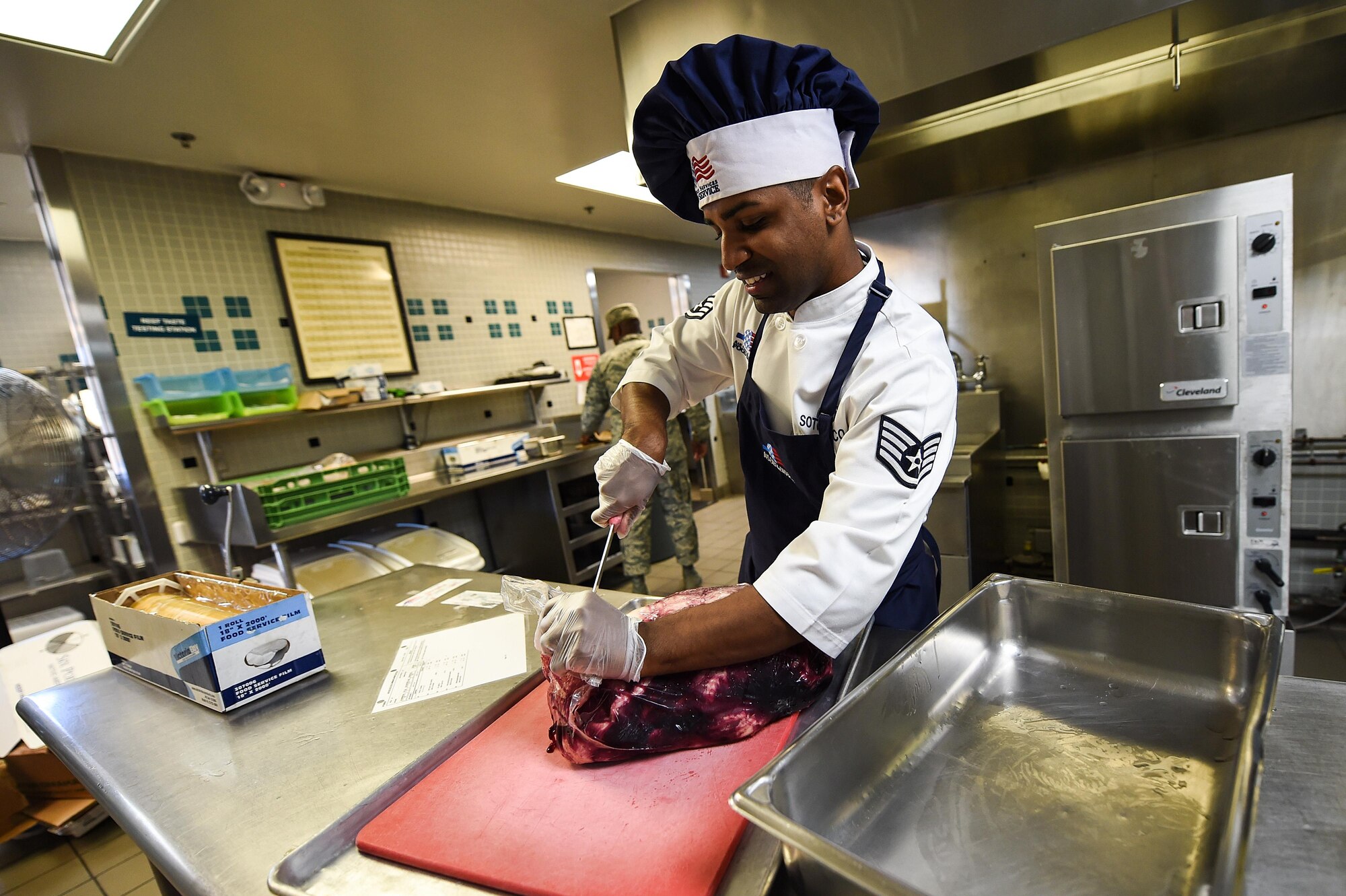 Staff. Sgt. Raymond Soto-Pacheco, a food shift supervisor with the 1st Special Operations Force Support Squadron, prepares meat at the Reef dining facility on Hurlburt Field, Fla., Oct. 13, 2016. The Reef staff receives a menu from the Air Force Services Activity unit and tailors it to fit the operational needs of the facility. (U.S. Air Force photo by Senior Airman Jeff Parkinson)