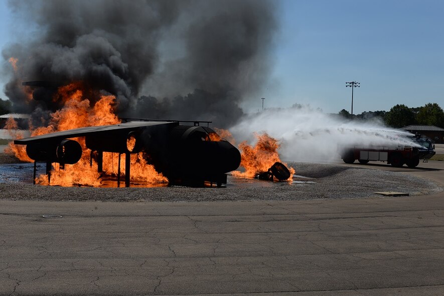 Crash 9, a firetruck, demonstrates its capacity to fight fires on trainer aircraft Oct. 8, 2016, during the Fire Prevention Week open house at Columbus Air Force Base, Mississippi. Crash 9, the most robust vehicle in their fleet, has the capacity to store enough water to put out even the toughest engine fires according to many firefighters. (U.S. Air Force photo by Airman 1st Class John Day)