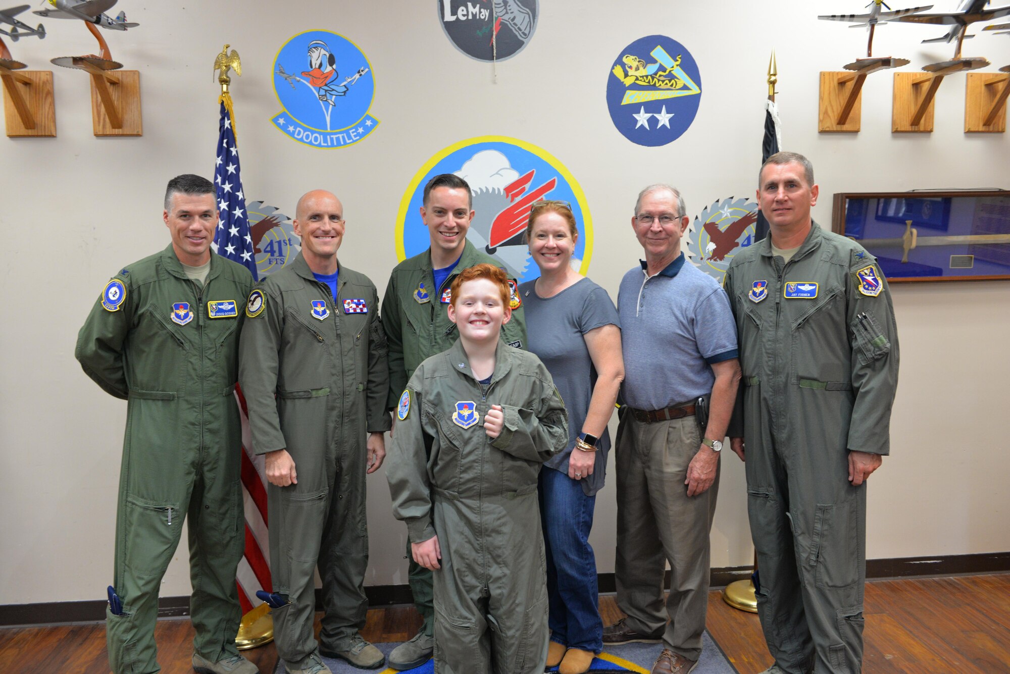 Griffin Threatt, Pilot for a Day, poses for a photo with his family and base leadership Oct. 7 on Columbus Air Force Base, Mississippi. The Pilot for a Day program invites children with chronic illnesses to the base for a day of fun and relaxation and to experience the life of an Air Force pilot. (U.S. Air Force photo/2nd Lt. Savannah Knight)