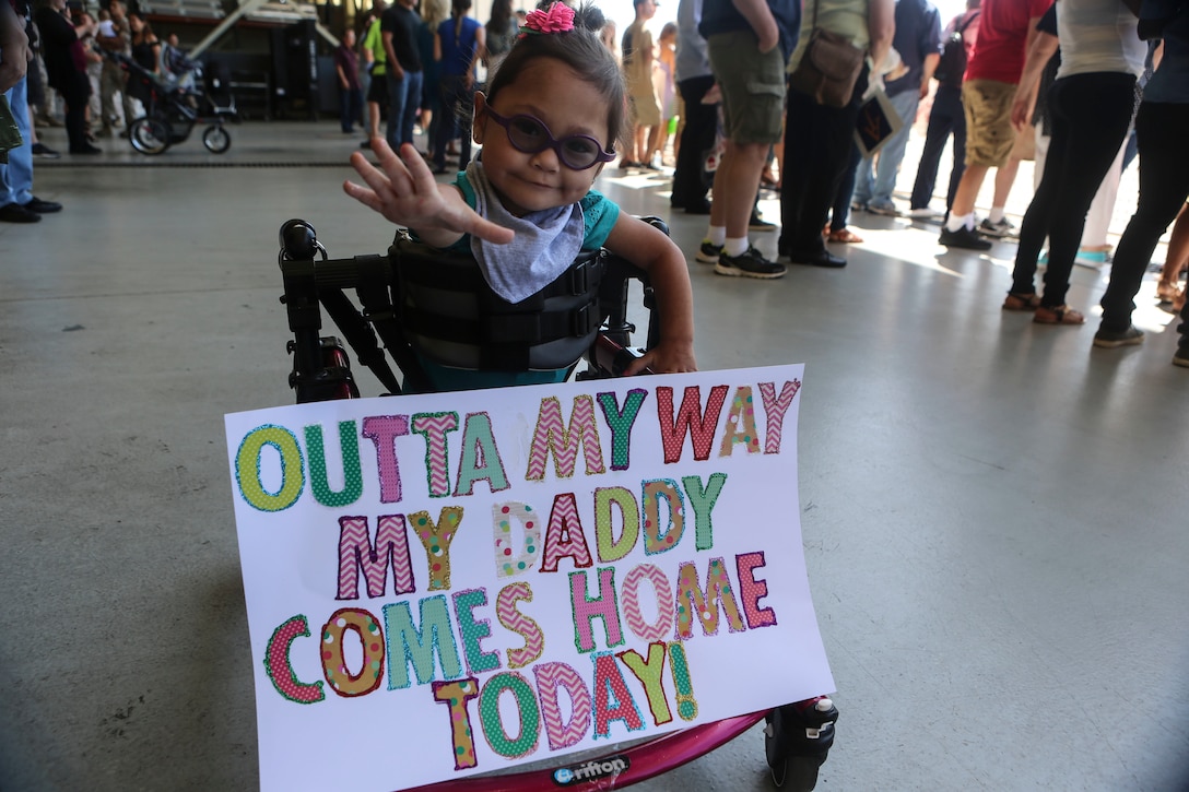 Briella, 2, awaits the arrival of Gunnery Sgt. Travis Borkowski, a crew chief with Marine Medium Tiltrotor Squadron (VMM) 166, during a homecoming ceremony for the 13th Marine Expeditionary Unit aboard Marine Corps Air Station Miramar, Calif., Sept. 10.  During his deployment, Borkowski and his wife Megan officially adopted Briella after fostering her for almost two years. (U.S. Marine Corps photo by Lance Cpl. Harley Robinson/Released)