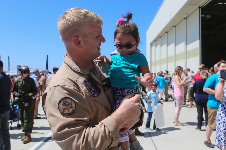 Gunnery Sgt. Travis Borkowski, a crew chief with Marine Medium Tiltrotor Squadron (VMM) 166, reunites with his adopted daughter Briella Borkowski, 2, during a homecoming ceremony for the aviation combat element of the 13th Marine Expeditionary Unit aboard Marine Corps Air Station Miramar, Calif., Sept. 10. During his deployment, Borkowski and his wife Megan officially adopted Briella after fostering her for almost two years. (U.S. Marine Corps photo by Lance Cpl. Harley Robinson/Released)