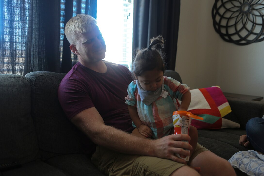 Gunnery Sgt. Travis Borkowski, a crew chief with Marine Medium Tiltrotor Squadron (VMM) 166, watches Briella Borkowski, 2, as she feeds herself at the Borkowski’s home aboard Marine Corps Air Station Miramar, Calif., Sept. 14. Borkowski recently returned from deployment, during which he and his wife Megan officially adopted Briella after fostering her for almost two years. Briella just recently learned to feed herself, slowly overcoming physical disabilities to do so. (U.S. Marine Corps photo by Lance Cpl. Harley Robinson/Released)