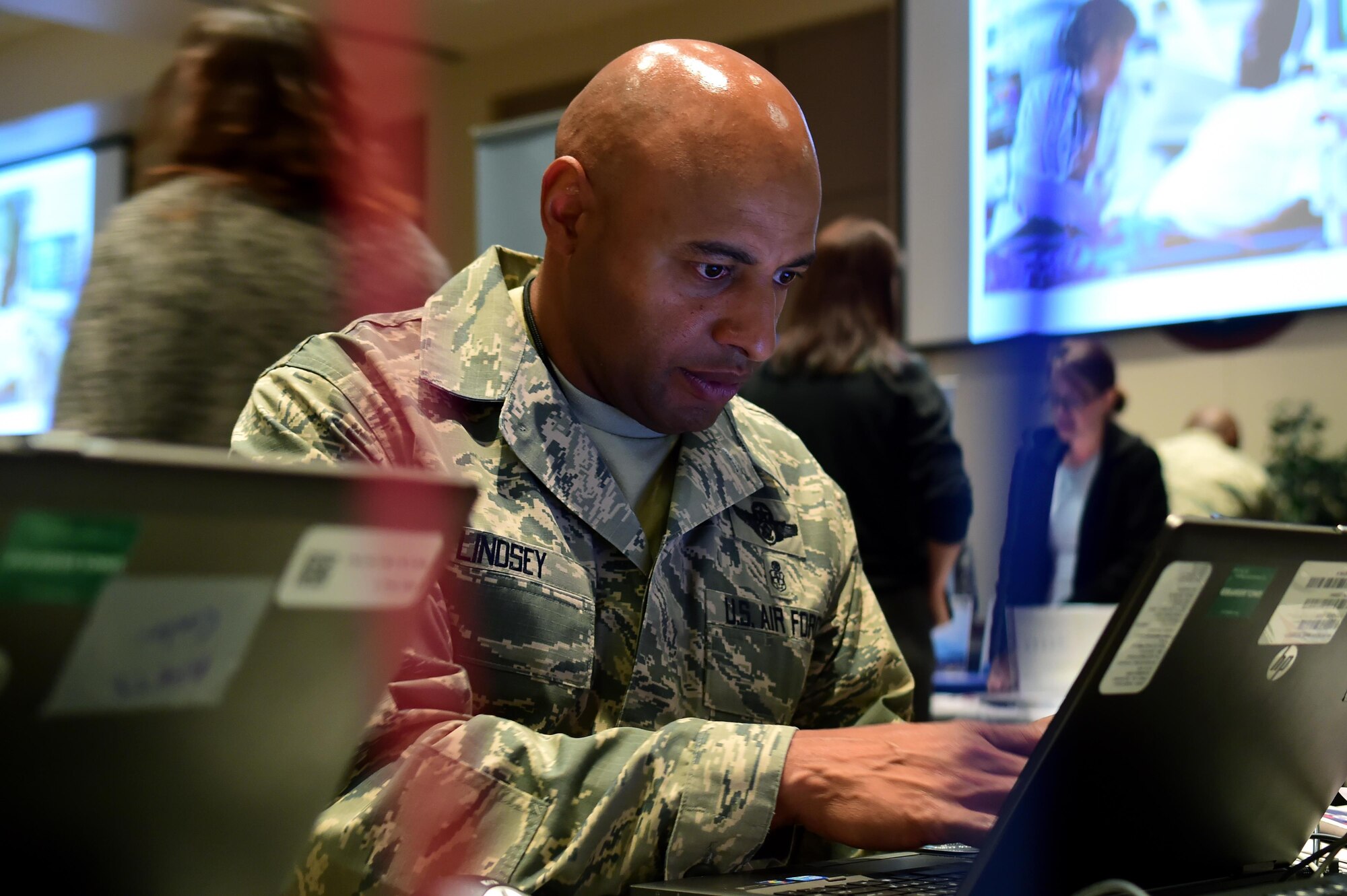 Chief Master Sgt. Rod Lindsey, 460th Space Wing command chief, selects organizations to donate to during the Combined Federal Campaign fair Oct. 12, 2016, on Buckley Air Force Base, Colo. The command team, including Lindsey and Col. David Miller Jr., 460th Space Wing commander, chose organizations to help support the CFC. (Air Force photo by Airman Holden S. Faul/ Released)