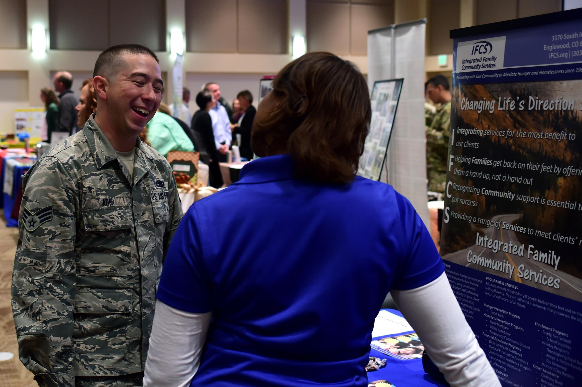 Senior Airman Edward Abe, 302nd Maintenance Squadron communication navigation technician, speaks with a representative from Integrated Family Community Services during the Combined Federal Campaign fair Oct. 12, 2016, on Buckley Air Force Base. Team Buckley members are now able to donate to the organization of their choice. (Air Force photo by Airman Holden S. Faul/Released)