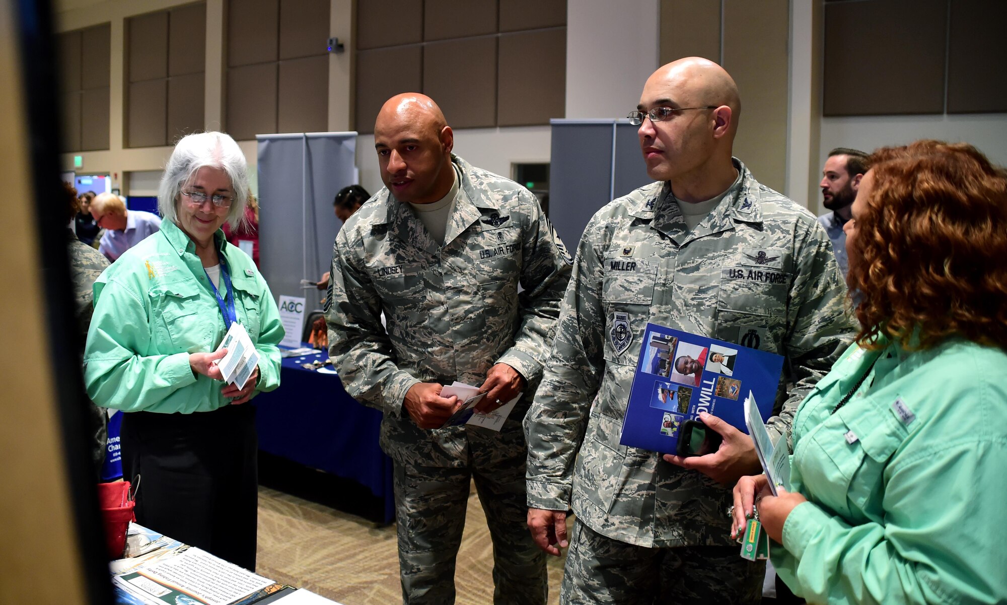 Col. David Miller Jr.(right), 460th Space Wing commander and Chief Master Sgt. Rod Lindsey, 460th Space Wing command chief, visit with organizations to learn more about their mission during the Combined Federal Campaign fair Oct. 12, 2016, on Buckley Air Force Base, Colo. More than 70 organizations attended the fair to educate base members on their options for donating. (Air Force photo by Airman Holden S. Faul/Released)