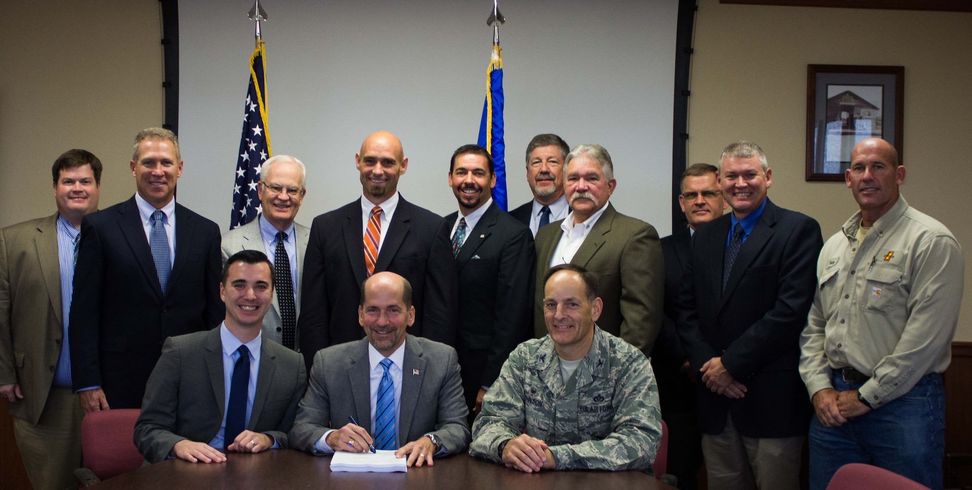 Air Force and commercial personnel involved with the recent utilities privatization at Eglin Air Force Base, Florida, pose for a photo at the contract award meeting Oct. 4. (U.S. Air Force Photo/Jessica Dupree/Released)