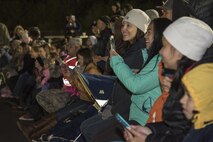 Families and service members take photos of a simulated aircraft crash burn at Misawa Air Base, Japan, Oct. 12, 2016. Approximately 80 attended the event including a mixture of Japanese nationals, U.S. Air Force and Navy service members and their families. The event included five fire scenarios and a dance-off between Smokey the Bear and Sparky the Fire Dog. The fire department's goal was to demonstrate firefighting tactics used by the firefighters. (U.S. Air Force photo by Airman 1st Class Sadie Colbert)