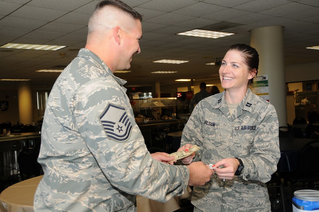 As part of a Combined Federal Campaign fundraiser, Master Sgt. Shane Potts, 185th Air Refueling Wing Civil Engineering Squadron, sells a raffle ticket for a chance to win a parking spot for a year, to Capt. Jennifer Carlson, 185th ARW Logistics Readiness Squadron, following the kickoff of the CFC at the Iowa Air National Guard base in Sioux City, Iowa on October 13, 2016.  The annual fundraiser began today and will wrap up on December 15, 2016.
U.S. Air National Guard Photo by: Master Sgt. Vincent De Groot 185th ARW Wing PA/ released