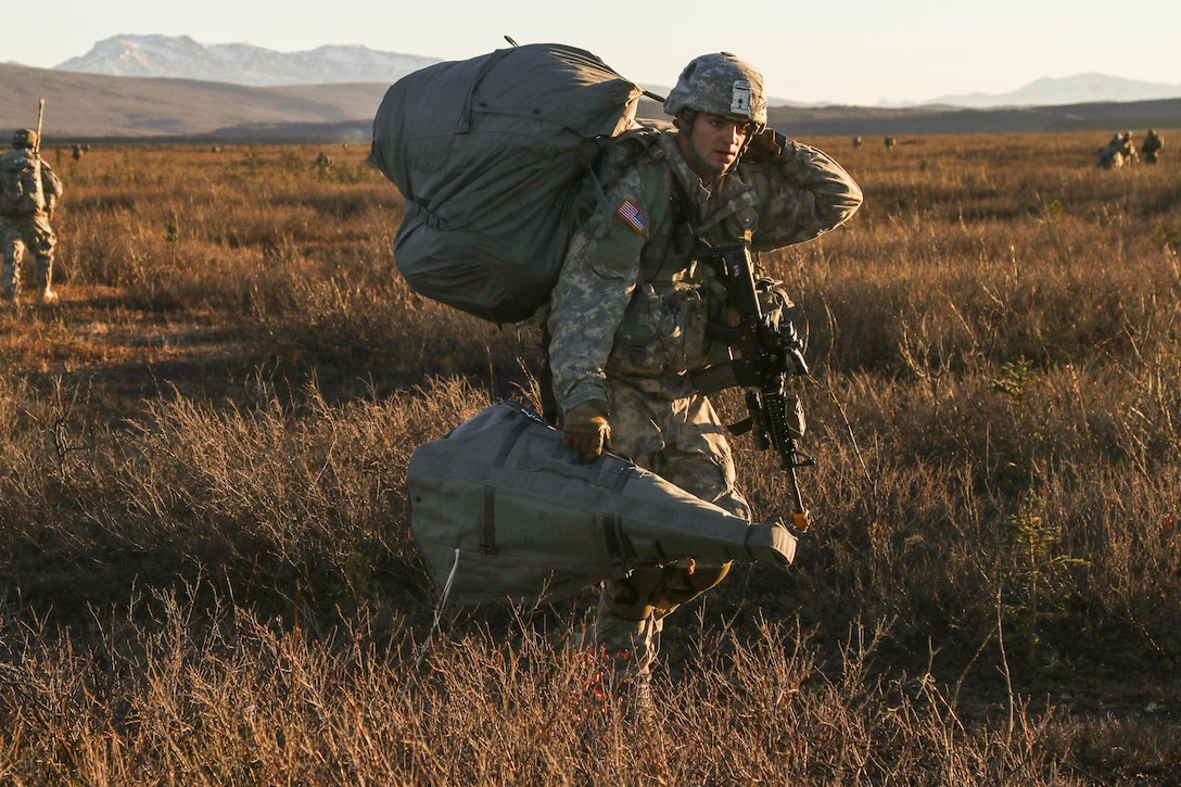 A paratrooper moves to assault an objective during Spartan Cerberus, an exercise, at Fort Greely, Alaska, Oct. 12, 2016. Army photo by Spc. Donald Williams