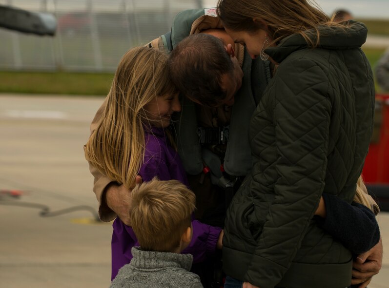 A 480th Expeditionary Fighter Squadron Airman embraces his family on the flightline at Spangdahlem Air Base, Germany, Oct. 6, 2016. Approximately 300 of the squadron’s Airmen, who serve in flight, maintenance or support roles for the F-16 Fighting Falcon fighter aircraft, completed a six-month deployment to Southwest Asia by providing close air support and dynamic targeting operations in support of Operation Inherent Resolve. (U.S. Air Force photo by Senior Airman Dawn M. Weber)