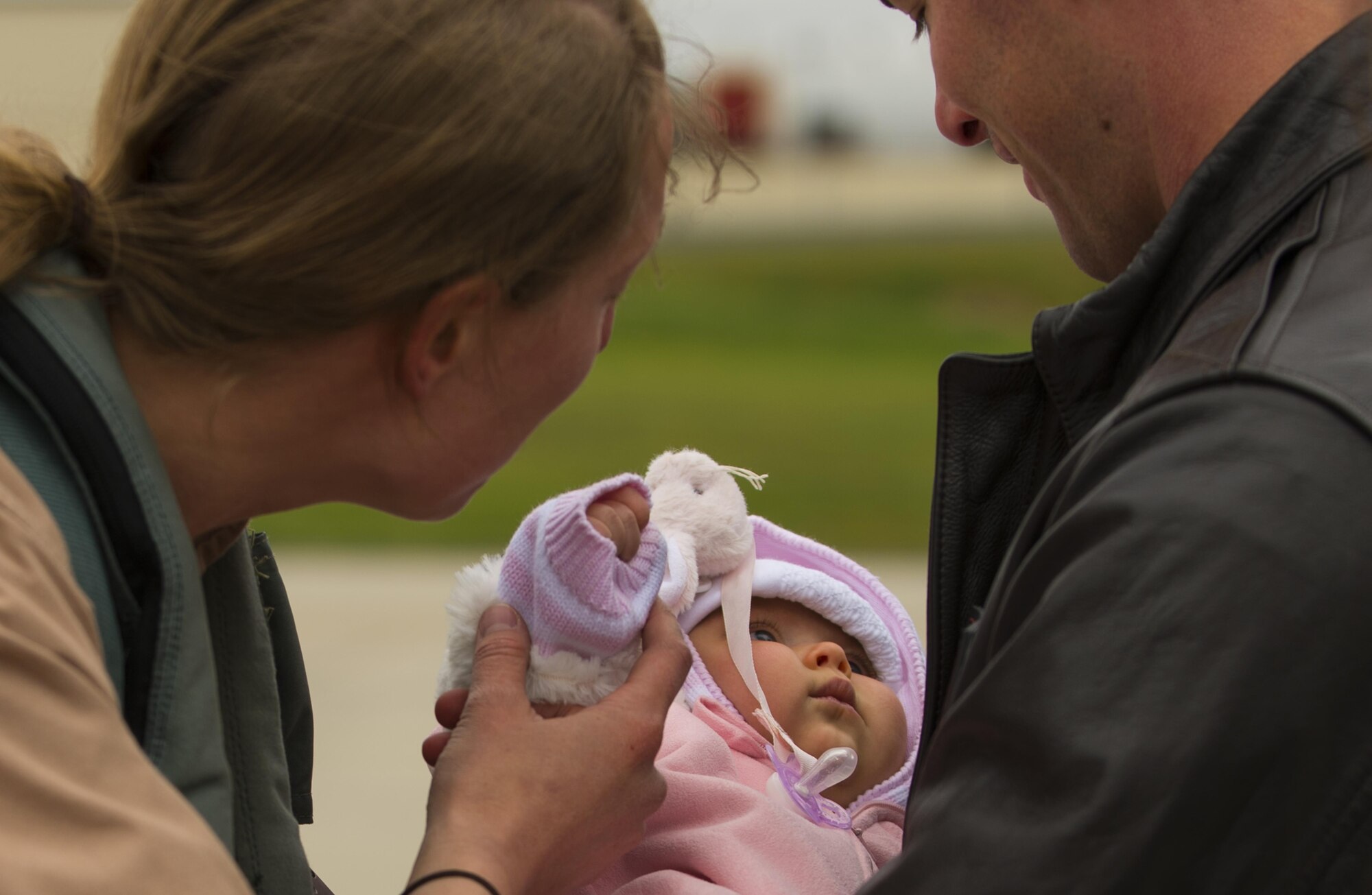 An Airman assigned to the 480th Expeditionary Fighter Squadron, left reunites with family and friends on the flightline at Spangdahlem Air Base, Germany, Oct. 6, 2016. Members of the 480th EFS and supporting agencies deployed to support Operation Inherent Resolve, a targeted operation against ISIL terrorists. (U.S. Air Force photo by Senior Airman Dawn M. Weber)