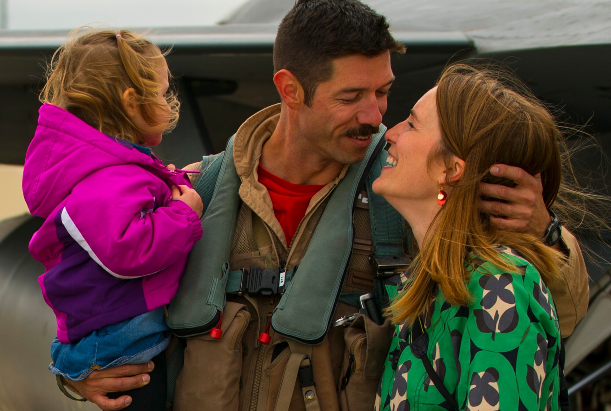 An Airman from the 480th Expeditionary Fighter Squadron embraces his wife during a homecoming event on the flightline at Spangdahlem Air Base, Germany, Oct. 6, 2016. The 480th EFS returned safely to home station after a six-month deployment to Southwest Asia. (U.S. Air Force photo by Senior Airman Dawn M. Weber)