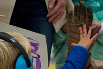 An Airman assigned to the 480th Expeditionary Fighter Squadron high-fives his son's hand during the squadron’s return to Spangdahlem Air Base, Germany, Oct. 6, 2016. Approximately 300 of the Airmen, who serve in flight, maintenance or support roles for the F-16 Fighting Falcon fighter aircraft, completed a six-month deployment to Southwest Asia by providing close air support and dynamic targeting operations as part of the squadron’s first deployment in support of Operation Inherent Resolve. Operation Inherent Resolve aims to eliminate the Da'esh terrorist group and the threat they pose to Iraq, Syria and the wider international community. (U.S. Air Force photo by Staff Sgt. Joe W. McFadden)
