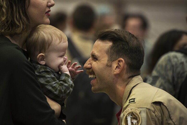 An Airman assigned to the 480th Expeditionary Fighter Squadron reunite with his family during the squadron’s
return to Spangdahlem Air Base, Germany, Oct. 12, 2016. Approximately 300 of the squadron’s Airmen, who serve
in flight, maintenance or support roles for the F-16 Fighting Falcon fighter aircraft, completed a six-month
deployment to Southwest Asia by providing close air support and dynamic targeting operations in support of
Operation Inherent Resolve. (U.S. Air Force photo by Staff Sgt. Jonathan Snyder)
