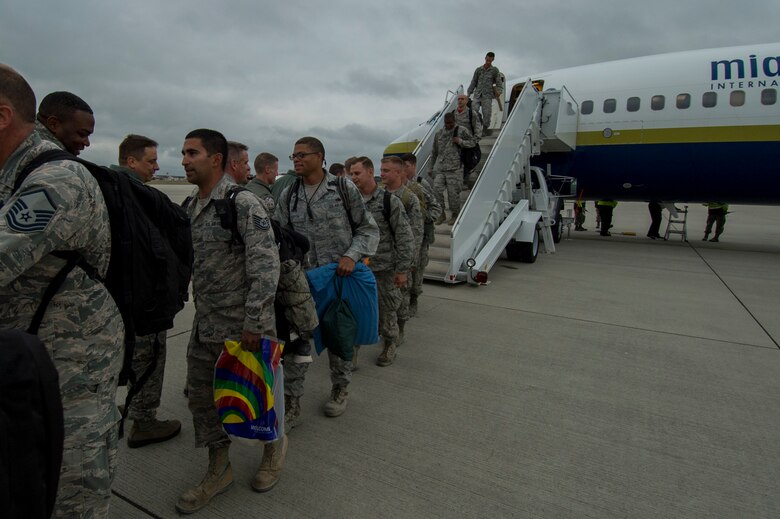 Airmen assigned to the 480th Expeditionary Fighter Squadron exit an airplane during the squadron’s return to Spangdahlem Air Base, Germany, Oct. 12, 2016. Approximately 300 of the Airmen, who serve in flight, maintenance or support roles for the F-16 Fighting Falcon fighter aircraft, completed a six-month deployment to Southwest Asia by providing close air support and dynamic targeting operations as part of the squadron’s first deployment in support of Operation Inherent Resolve. Operation Inherent Resolve aims to eliminate the Da'esh terrorist group and the threat they pose to Iraq, Syria and the wider international community. (U.S. Air Force photo by Staff Sgt. Joe W. McFadden)