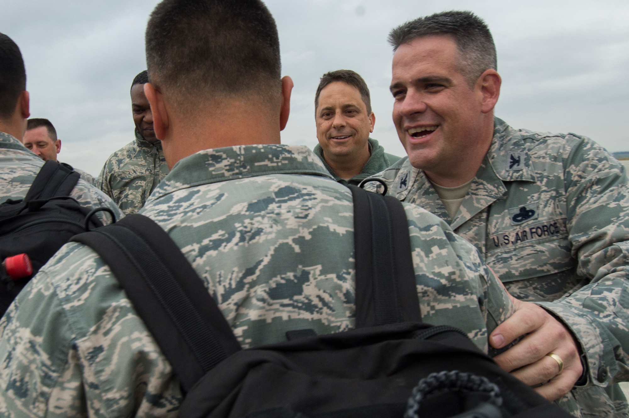 Col. Stephen Scherzer, 52nd Maintenance Group commander, right, greets an Airman assigned to the 480th Expeditionary Fighter Squadron during the squadron’s return to Spangdahlem Air Base, Germany, Oct. 12, 2016. Approximately 300 of the Airmen, who serve in flight, maintenance or support roles for the F-16 Fighting Falcon fighter aircraft, completed a six-month deployment to Southwest Asia by providing close air support and dynamic targeting operations as part of the squadron’s first deployment in support of Operation Inherent Resolve. Operation Inherent Resolve aims to eliminate the Da'esh terrorist group and the threat they pose to Iraq, Syria and the wider international community. (U.S. Air Force photo by Staff Sgt. Joe W. McFadden)
