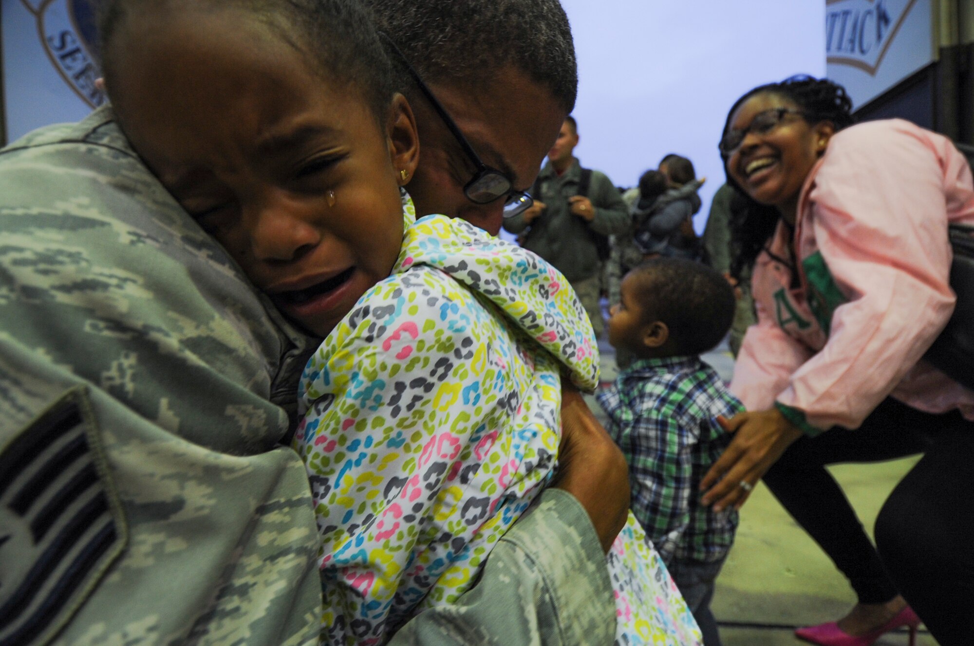 An Airman assigned to the 480th Expeditionary Fighter Squadron holds his daughter during the squadron’s return to Spangdahlem Air Base, Germany, Oct. 12, 2016. Approximately 300 of the Airmen, who serve in flight, maintenance or support roles for the F-16 Fighting Falcon fighter aircraft, completed a six-month deployment to Southwest Asia by providing close air support and dynamic targeting operations as part of the squadron’s first deployment in support of Operation Inherent Resolve. Operation Inherent Resolve aims to eliminate the Da'esh terrorist group and the threat they pose to Iraq, Syria and the wider international community. (U.S. Air Force photo by Staff Sgt. Joe W. McFadden)