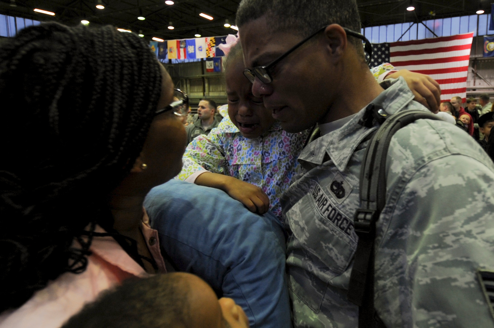 An Airman assigned to the 480th Expeditionary Fighter Squadron reunites with his family during the squadron’s return to Spangdahlem Air Base, Germany, Oct. 12, 2016. Approximately 300 of the Airmen, who serve in flight, maintenance or support roles for the F-16 Fighting Falcon fighter aircraft, completed a six-month deployment to Southwest Asia by providing close air support and dynamic targeting operations as part of the squadron’s first deployment in support of Operation Inherent Resolve. Operation Inherent Resolve aims to eliminate the Da'esh terrorist group and the threat they pose to Iraq, Syria and the wider international community. (U.S. Air Force photo by Staff Sgt. Joe W. McFadden)