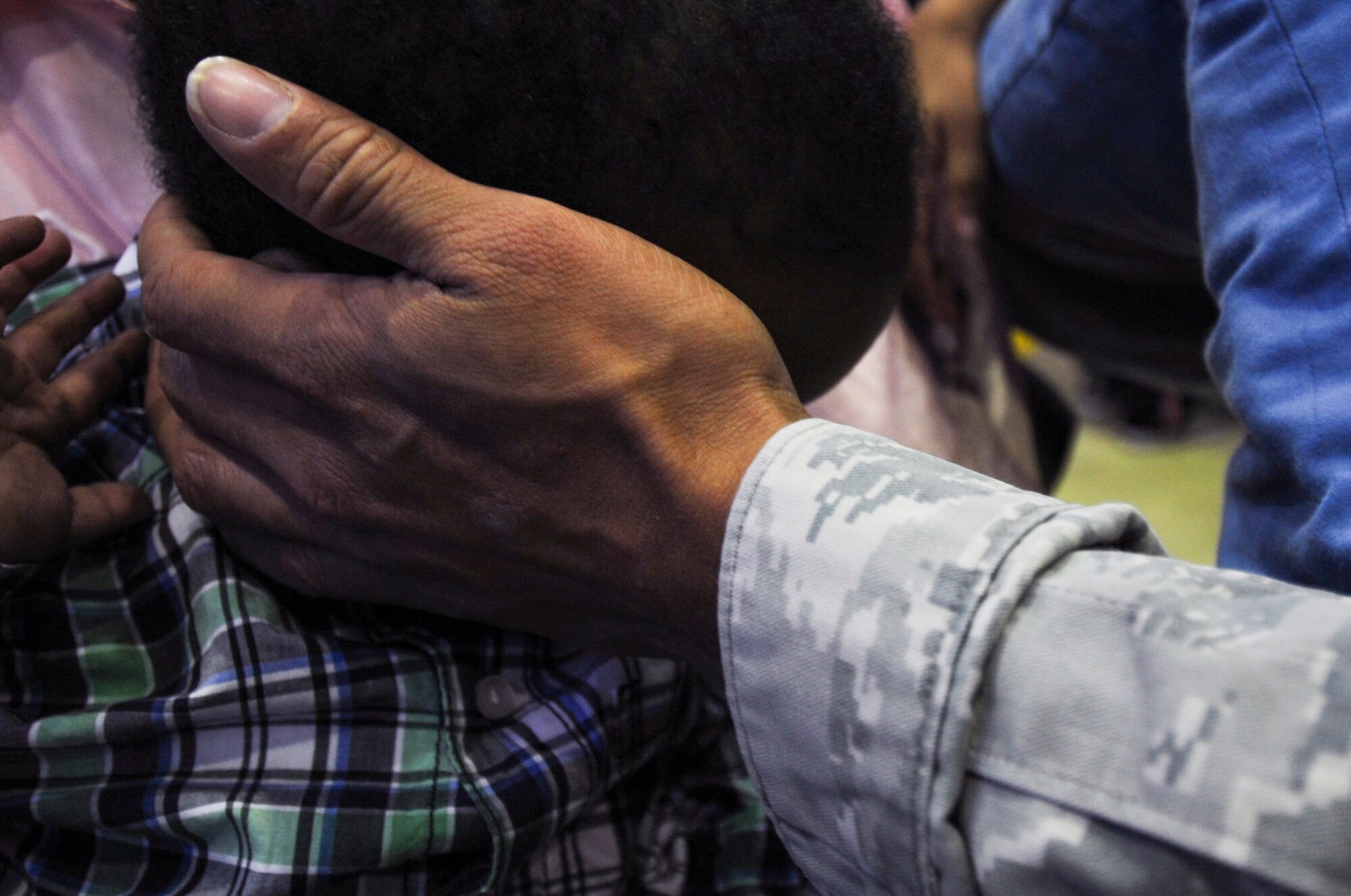 An Airman assigned to the 480th Expeditionary Fighter Squadron holds his son's head during the squadron’s return to Spangdahlem Air Base, Germany, Oct. 12, 2016. Approximately 300 of the Airmen, who serve in flight, maintenance or support roles for the F-16 Fighting Falcon fighter aircraft, completed a six-month deployment to Southwest Asia by providing close air support and dynamic targeting operations as part of the squadron’s first deployment in support of Operation Inherent Resolve. Operation Inherent Resolve aims to eliminate the Da'esh terrorist group and the threat they pose to Iraq, Syria and the wider international community. (U.S. Air Force photo by Staff Sgt. Joe W. McFadden)