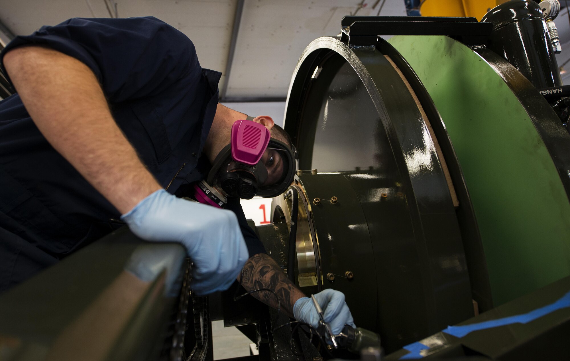 Staff Sgt. Kyle Morris, 435th Construction and Training Squadron aircraft arresting systems depot technician, checks his work while painting a BAK-12 aircraft arresting system at Ramstein Air Base, Germany, Oct. 12, 2016. Morris painted the arresting system to prevent corroding. Each system requires an overhaul every ten years, and the 435th CTS is the only squadron within U.S. Air Forces in Europe with the capability to do so. (U.S. Air Force photo by Senior Airman Tryphena Mayhugh)