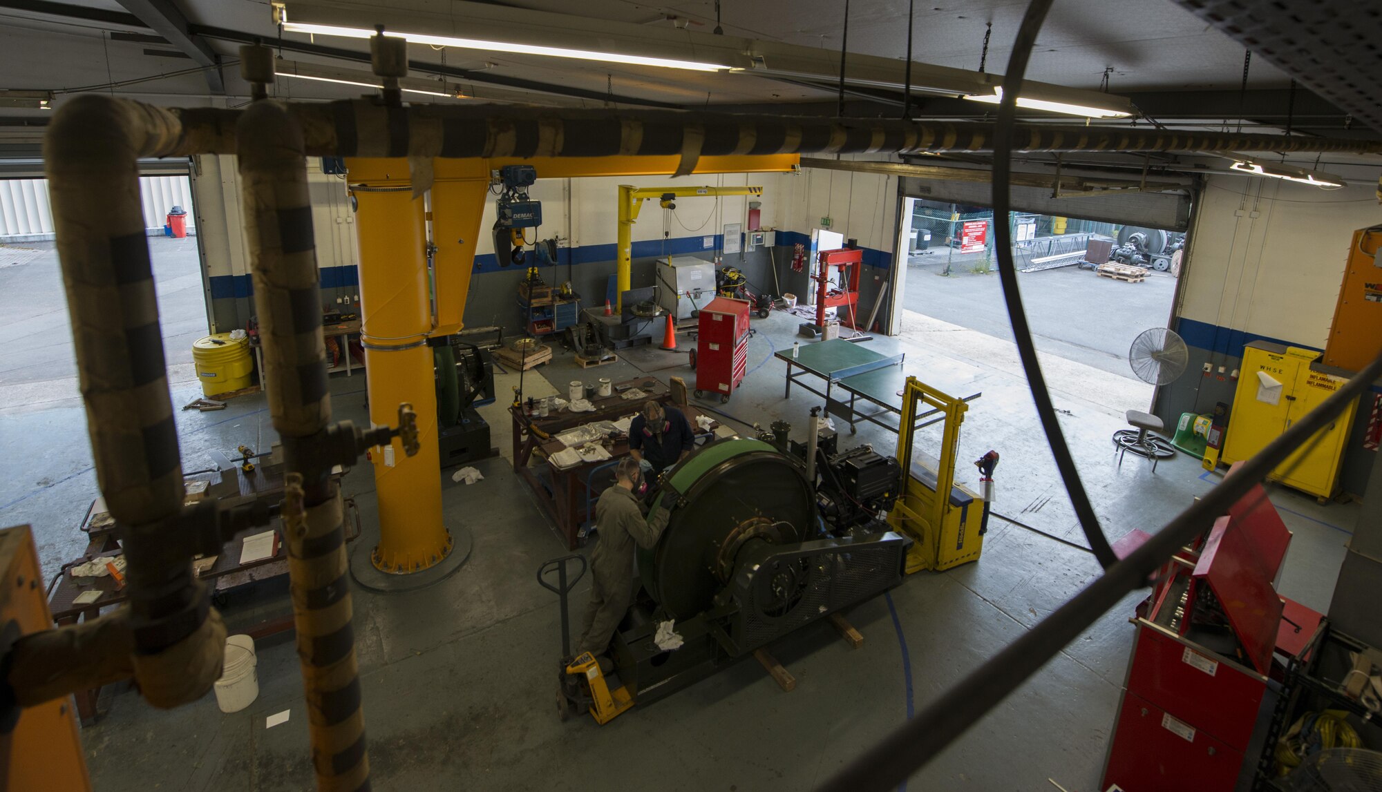Staff Sgt. Kyle Morris and Airman 1st Class Dylan Ryan, 435th Construction and Training aircraft arresting systems depot technicians, overhaul a BAK-12 aircraft arresting system at Ramstein Air Base, Germany, Oct. 12, 2016. The arresting system decelerates an aircraft during landing and each one requires an overhaul every ten years. The 435th CTS is the only squadron within U.S. Air Forces in Europe with the capability to provide this service. (U.S. Air Force photo by Senior Airman Tryphena Mayhugh)