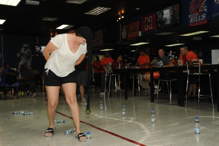 Senior Airman Nikki McWhirt, 386th Expeditionary Communications Squadron knowledge operations manager, tries to knock down bottles of water during Rockfest XV Oct. 8, 2016 at an undisclosed location in Southwest Asia. The objective of the event, dubbed elephant’s march, was to use a tennis ball placed inside panty hose to knock over bottles of water in the fastest time. (U.S. Air Force photo/Senior Airman Zachary Kee)