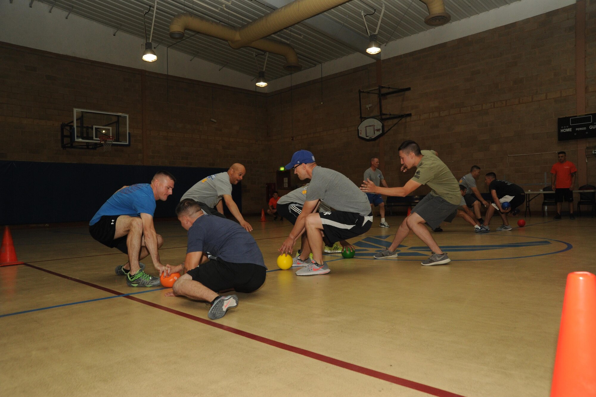 Teams dash to the middle of the court to gather balls during a game of medic dodgeball Oct. 8, 2016 at an undisclosed location in Southwest Asia. Dodgeball, a swim relay, deal or no deal, the dunk tank, and a boat race were the highlighted events during Rockfest XV and served as a midway point for many at the Rock. (U.S. Air Force photo/Senior Airman Zachary Kee)