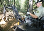 Ohio Army National Guard 1st Lt. Nick Mossbarger of the 216th Engineer Battalion uses an excavator to help construct a section of horse trail as part of his civilian job as a recreation technician for the Wayne National Forest in Southeast Ohio. This summer, Mossbarger was sent west to assist crews fighting wildfires in South Dakota, Colorado and Wyoming. 