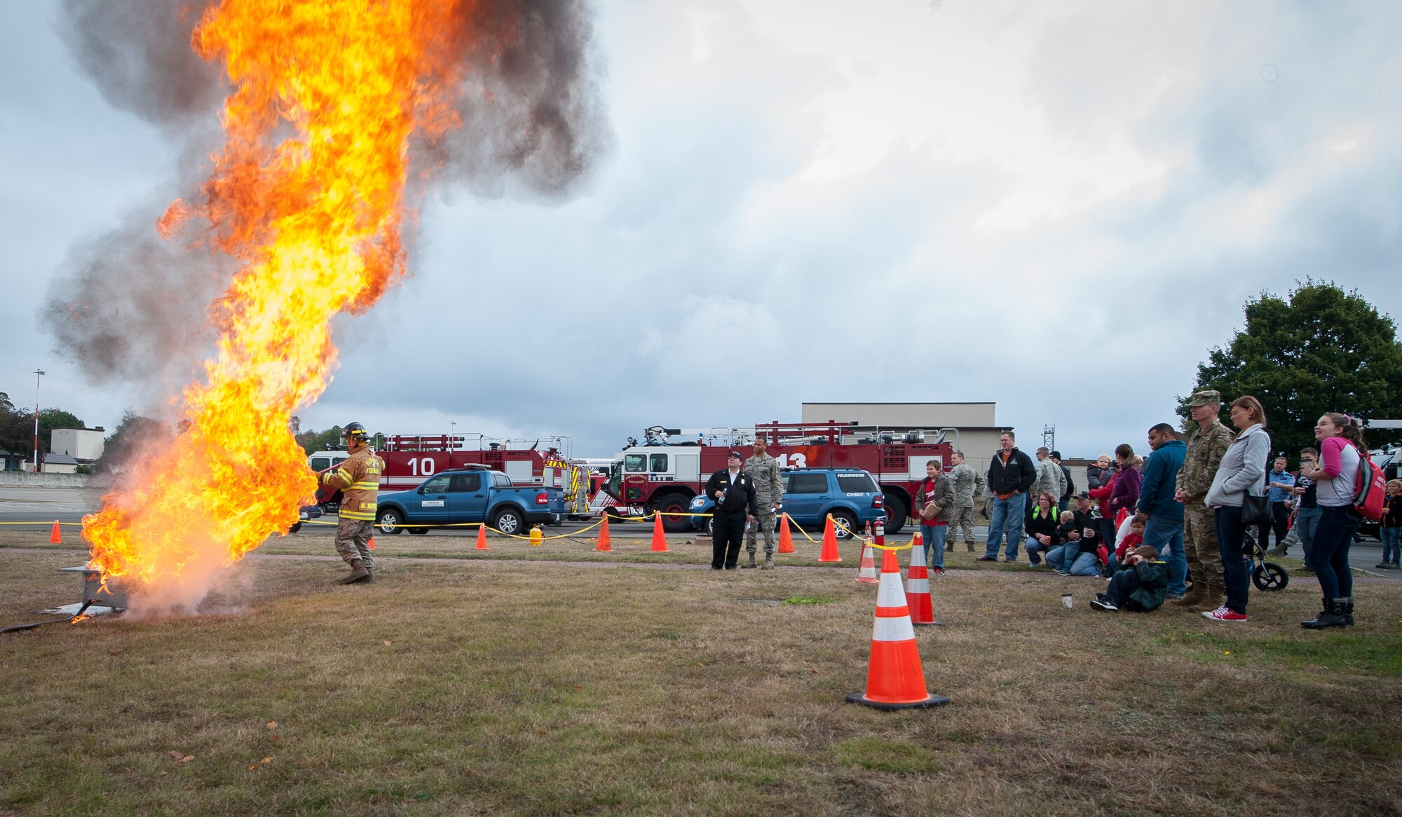 A firefighter assigned to the 786th Civil Engineer Squadron demonstrates to a crowd the effects of a grease fire during an open house at Ramstein Air Base, Germany, Oct. 8, 2016. According to the National Fire Prevention Association, 90 percent of house fires involve cooking equipment, with over half of those spawning from grease fires. (U.S. Air Force photo by Airman 1st Class Lane T. Plummer)