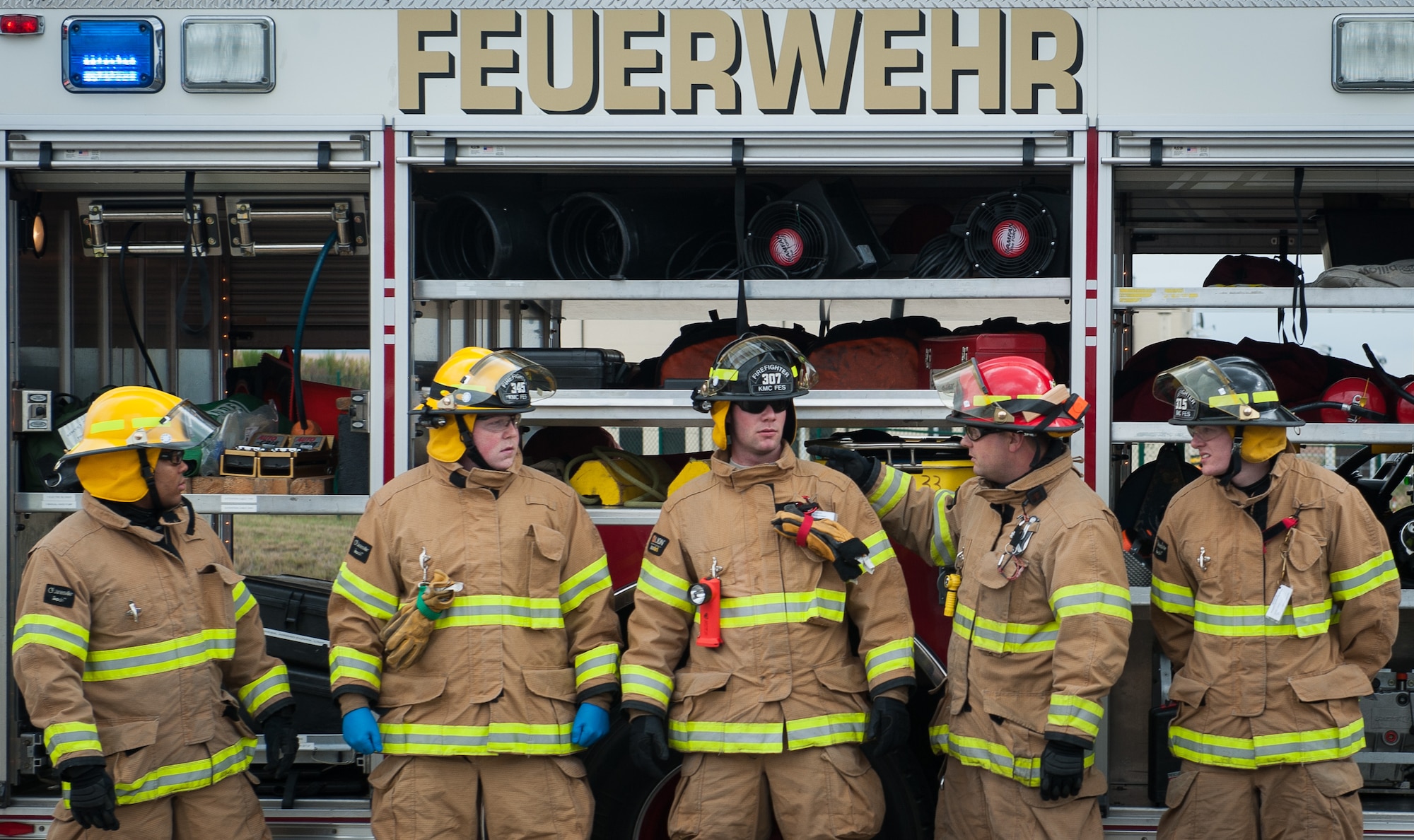 Firefighters assigned to the 786th Civil Engineering Squadron huddle together to prepare for a vehicle extrication training exercise during an open house event at Ramstein Air Base, Germany, Oct. 8, 2016. The exercise allowed onlookers to understand the aftermath of car accidents and what firefighters must do to save those involved in them. (U.S. Air Force photo by Airman 1st Class Lane T. Plummer)